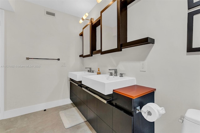 bathroom featuring sink, tile patterned floors, and toilet