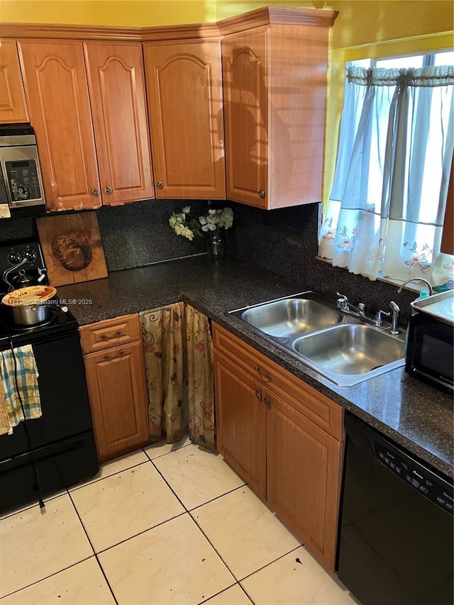 kitchen with light tile patterned floors, sink, tasteful backsplash, and black appliances