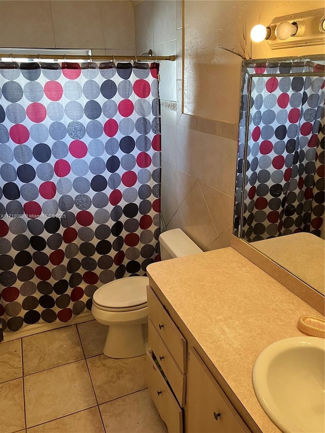 bathroom featuring curtained shower, tile patterned floors, vanity, and toilet