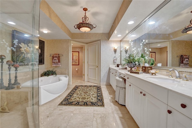 bathroom featuring a tub to relax in and vanity