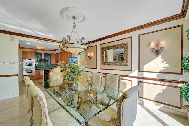 dining space featuring crown molding and an inviting chandelier