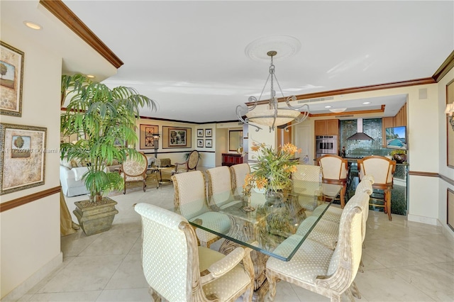 dining room featuring light tile patterned floors and crown molding