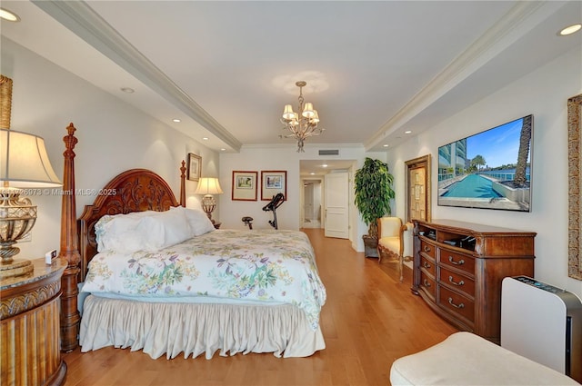 bedroom featuring light hardwood / wood-style floors, ornamental molding, and a notable chandelier