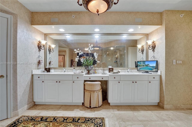 bathroom featuring a shower with shower door and vanity