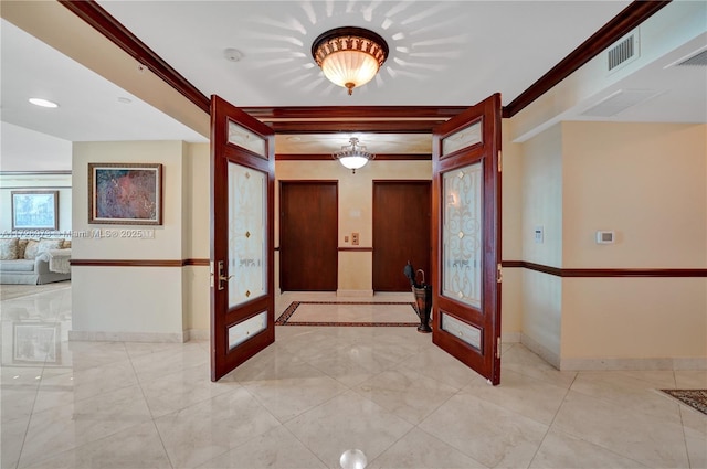 entryway featuring french doors and ornamental molding