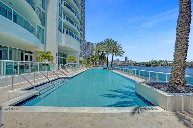 view of pool featuring a water view