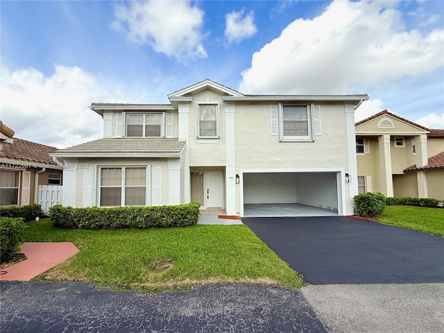 view of front of house featuring a garage and a front lawn