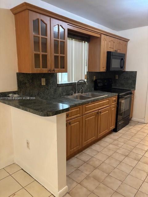 kitchen with backsplash, black appliances, kitchen peninsula, sink, and light tile patterned floors