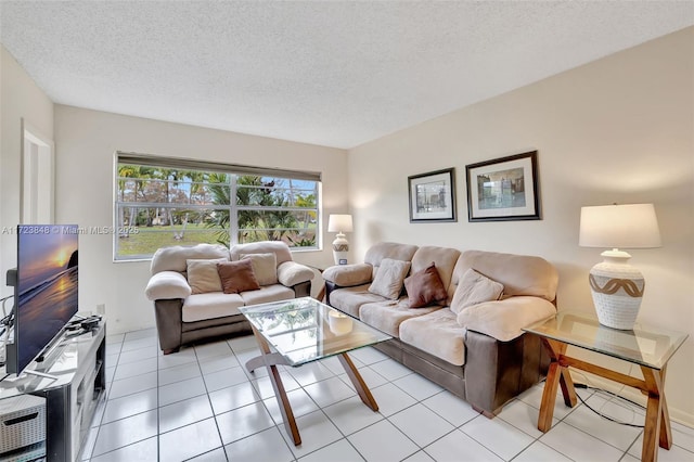 tiled living room featuring a textured ceiling