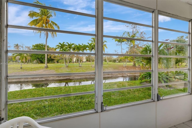 unfurnished sunroom with a water view