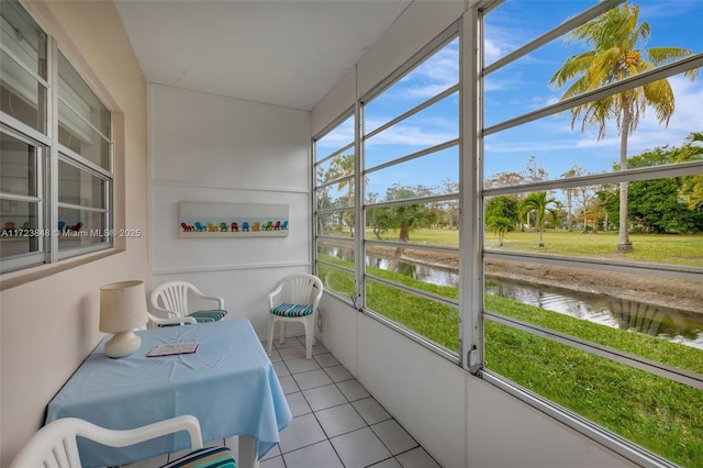 sunroom / solarium with plenty of natural light and a water view