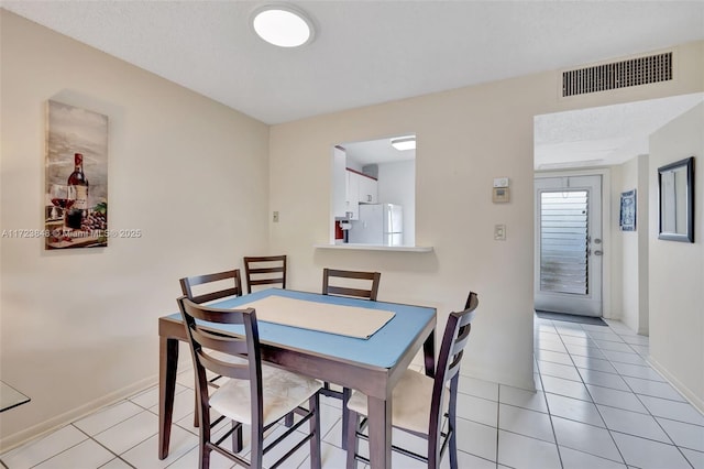 dining space with light tile patterned floors