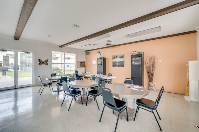 dining space with crown molding and beamed ceiling