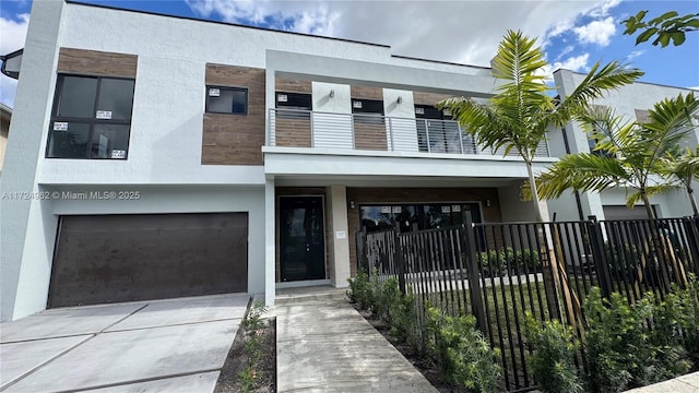 view of front facade featuring a garage and a balcony