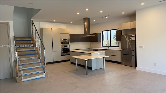 kitchen with a kitchen island, sink, appliances with stainless steel finishes, a breakfast bar area, and island range hood