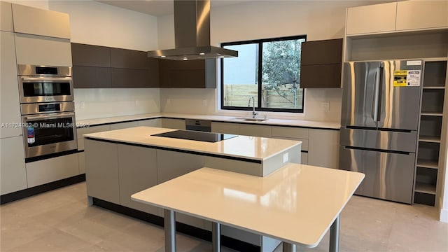 kitchen with sink, island range hood, a center island, and stainless steel appliances