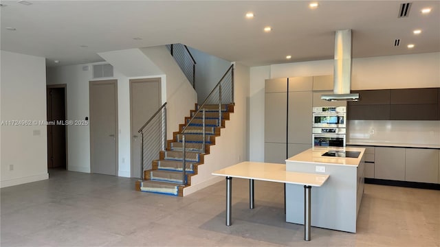 kitchen featuring island range hood, stainless steel double oven, black electric stovetop, a spacious island, and a breakfast bar