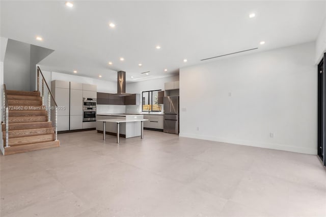 interior space with concrete flooring, baseboards, stairs, and recessed lighting
