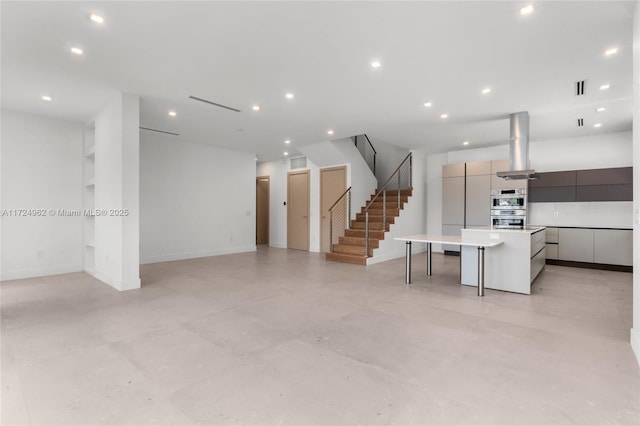 interior space featuring visible vents, baseboards, recessed lighting, and stairs