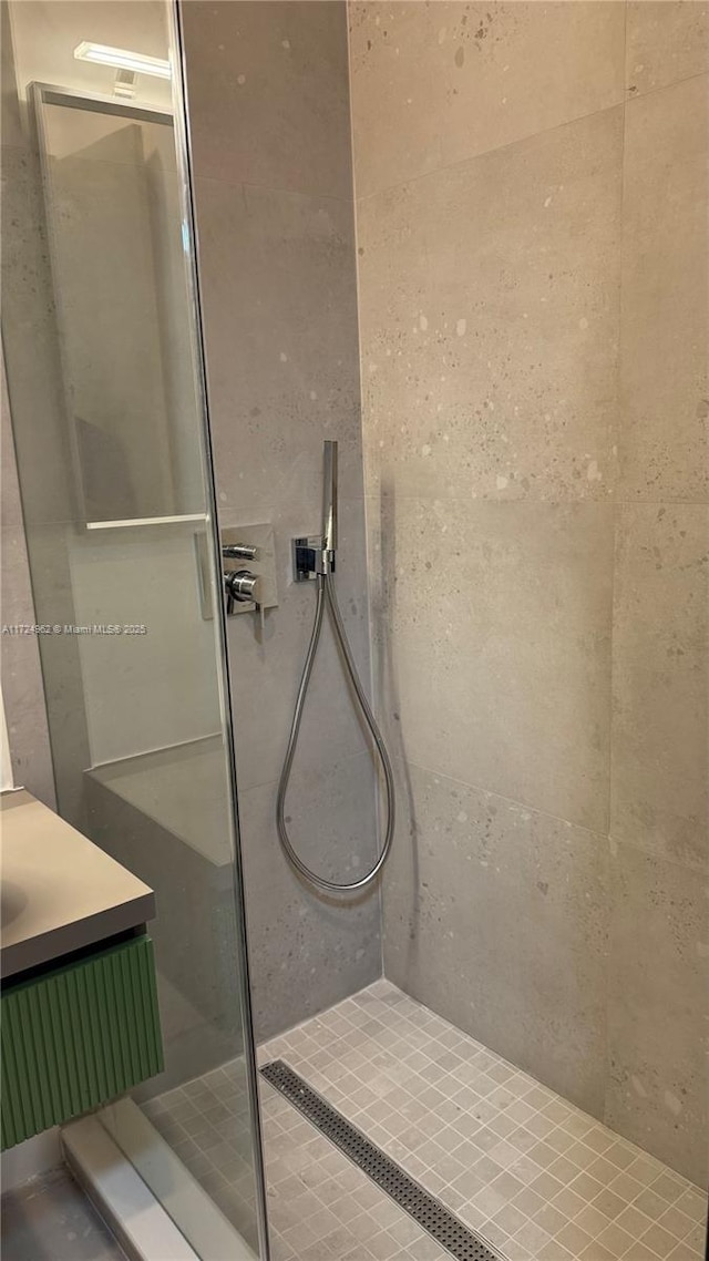 bathroom featuring vanity and a tile shower