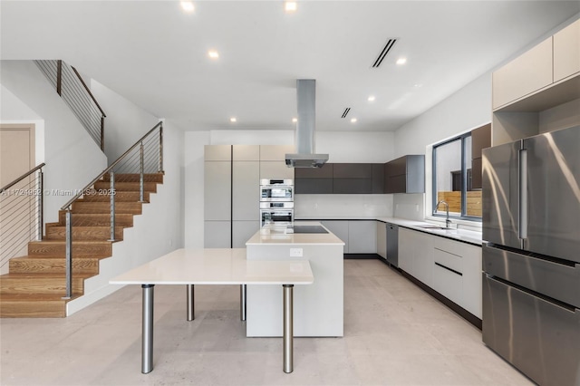 kitchen with a center island, a sink, island range hood, modern cabinets, and appliances with stainless steel finishes