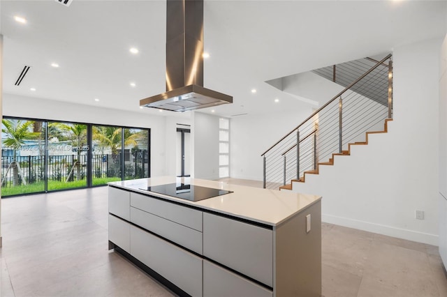 kitchen featuring open floor plan, island exhaust hood, modern cabinets, black electric cooktop, and white cabinetry