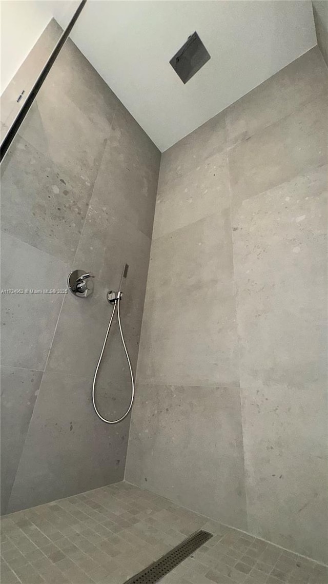 bathroom with tiled shower