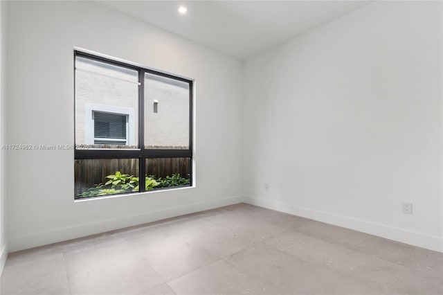 spare room with baseboards