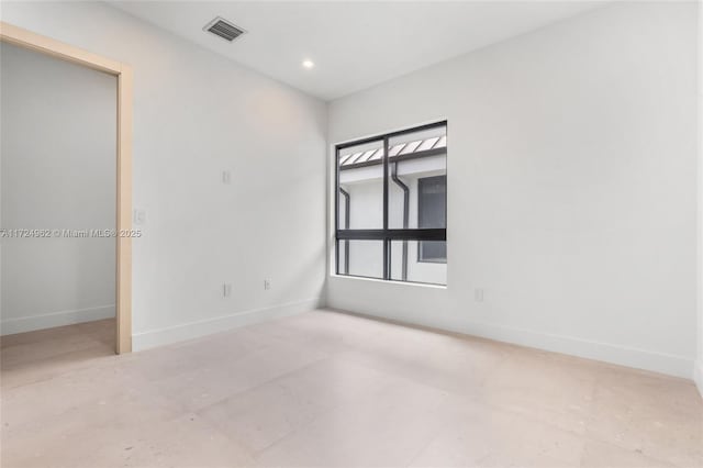 spare room with recessed lighting, visible vents, and baseboards