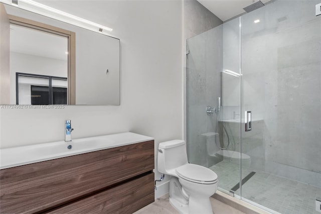 full bathroom with vanity, a shower stall, and toilet