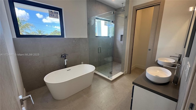 bathroom featuring a wealth of natural light, vanity, and shower with separate bathtub