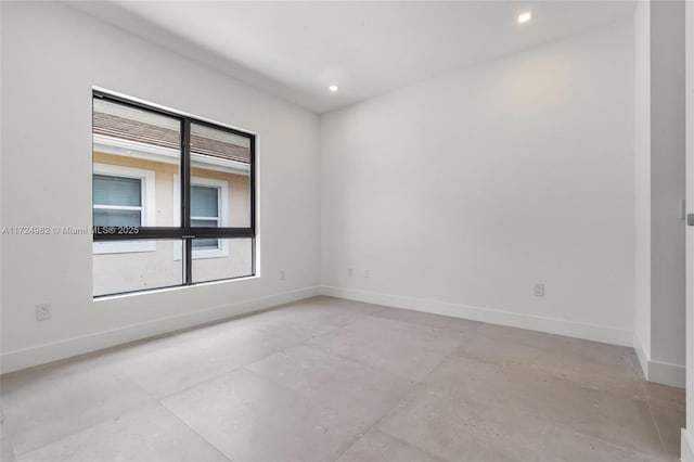 unfurnished room featuring baseboards and recessed lighting