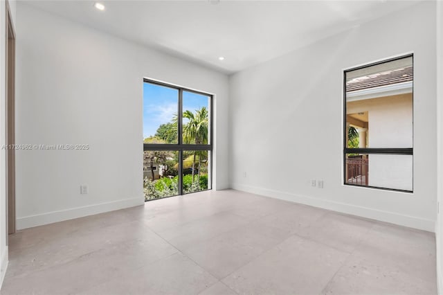 empty room with baseboards and recessed lighting