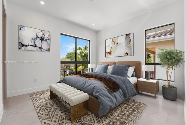 bedroom with concrete flooring, baseboards, and recessed lighting