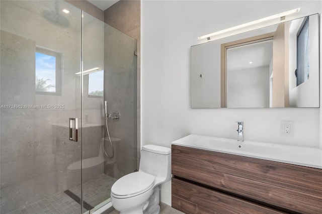 full bath featuring toilet, vanity, and a stall shower