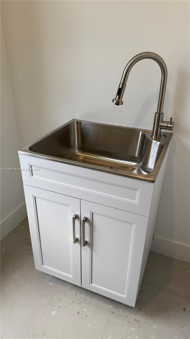 interior details with white cabinets and sink