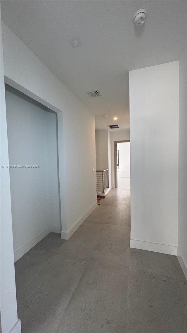 hallway with concrete floors