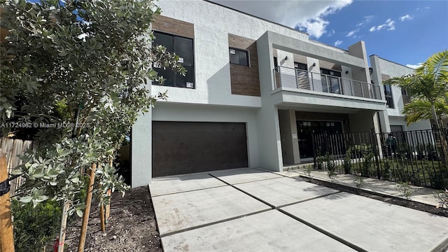 contemporary house with a garage and a balcony