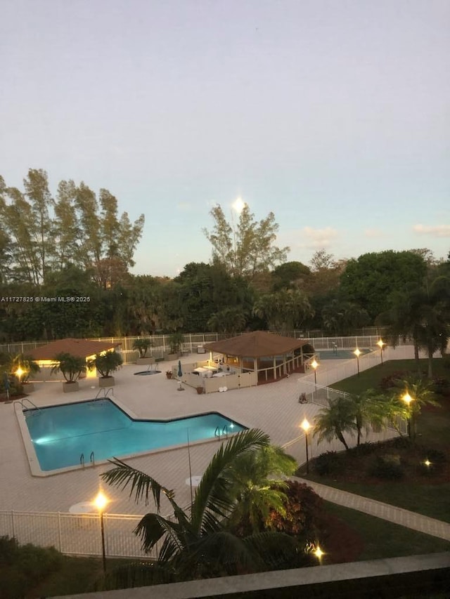 pool at dusk with a patio