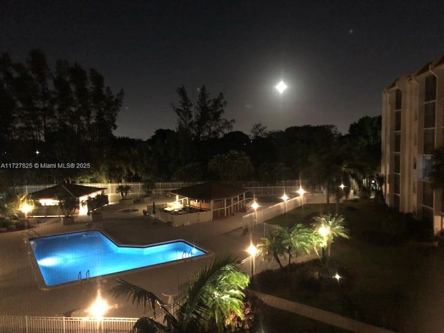 pool at night with a patio