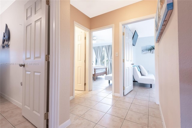 hallway featuring light tile patterned floors