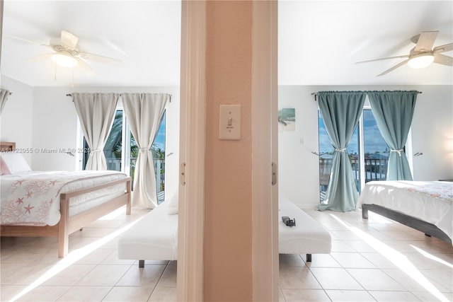 tiled bedroom featuring ceiling fan and access to outside