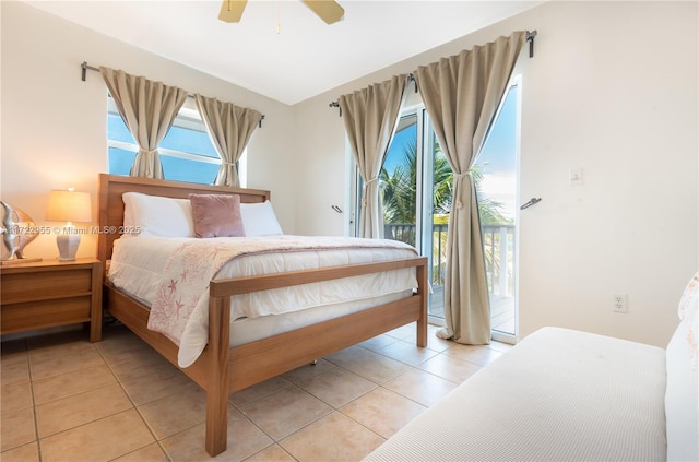 tiled bedroom with ceiling fan, access to outside, and multiple windows