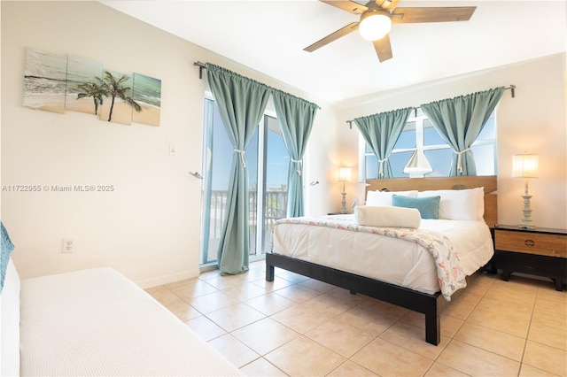 tiled bedroom featuring ceiling fan, access to exterior, and multiple windows