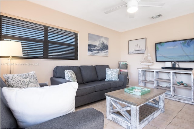 tiled living room featuring ceiling fan