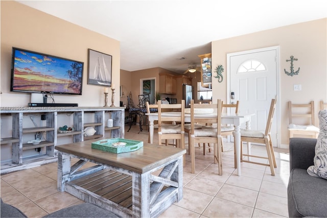 dining space with ceiling fan and light tile patterned flooring