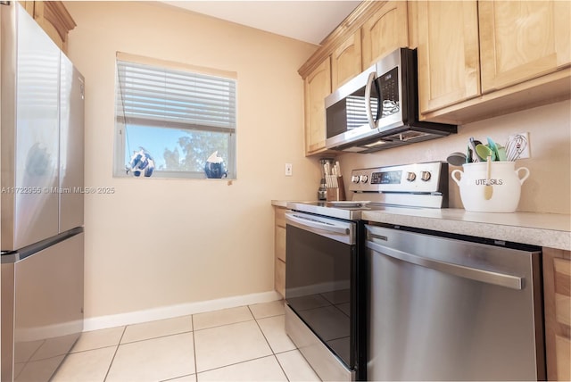 kitchen featuring light brown cabinets, stainless steel appliances, and light tile patterned flooring