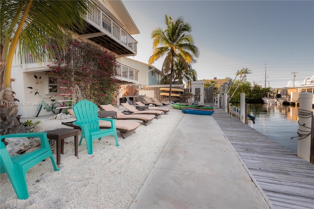 view of patio / terrace with a water view and a dock