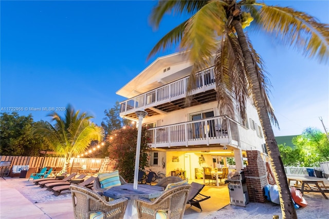 back of house featuring a patio area and a balcony