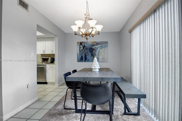 tiled dining space with a notable chandelier